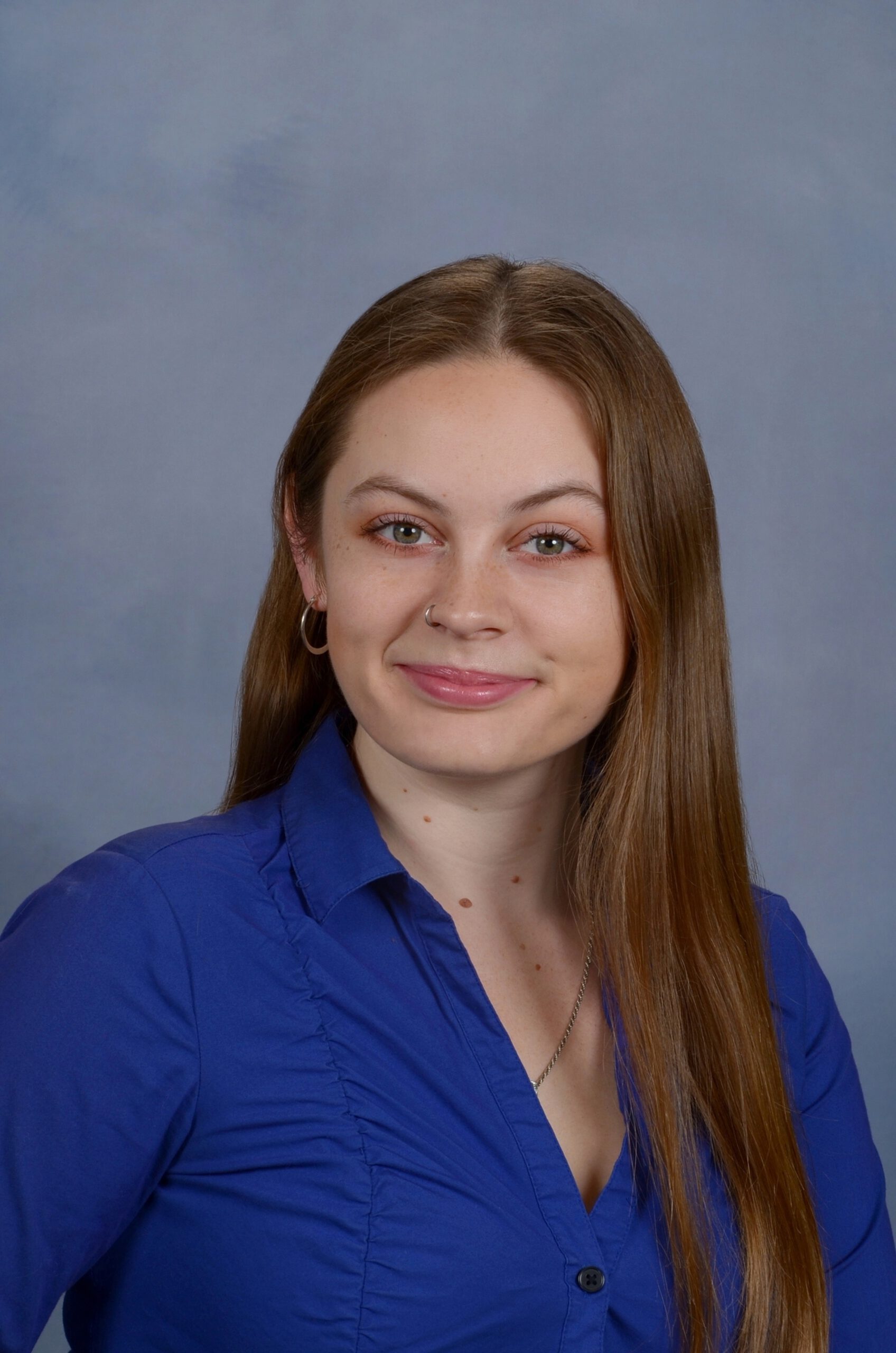 Headshot of Jordan in a blue shirt