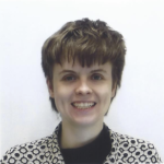 A headshot of Melissa in a printed, tan shirt