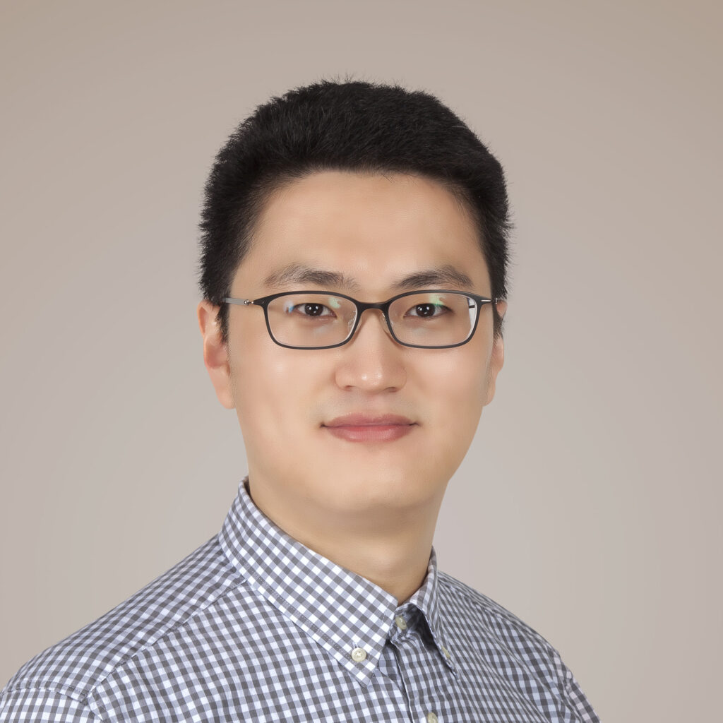 Quansan Yang's headshot, he is in a buttoned-up, checkered shirt.